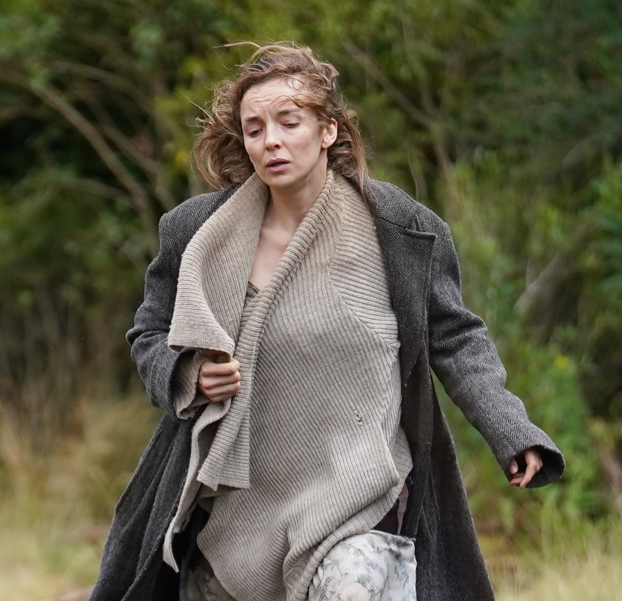 Jodie Comer runs in woods in pic from movie set