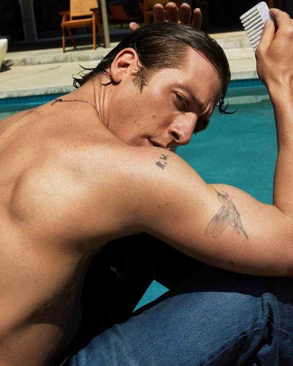 Jeremy Allen White shows off his tattoos by a pool for his Calvin Klein photo shoot in August 2024.