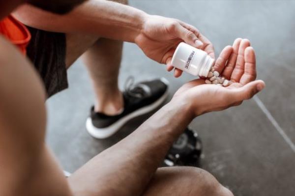 man taking probiotic pills
